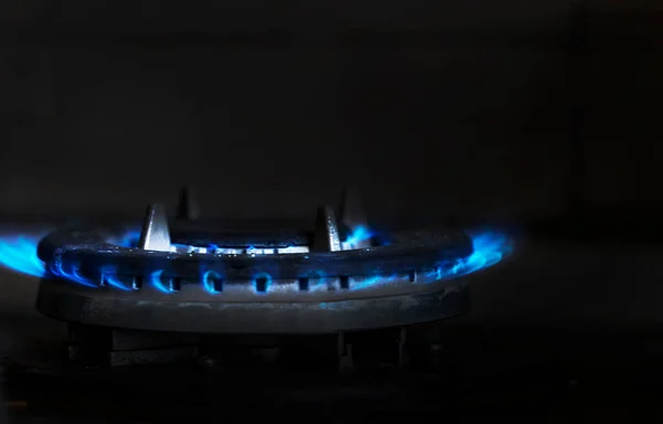 gas stove with gases turned on with low pressure on a dark background. Energy crisis. gas saving