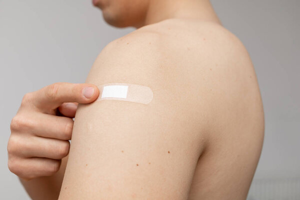happy man pointing at the patch on shoulder
