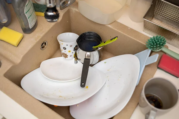 sink with dirty dishes cups and tableware. High quality photo