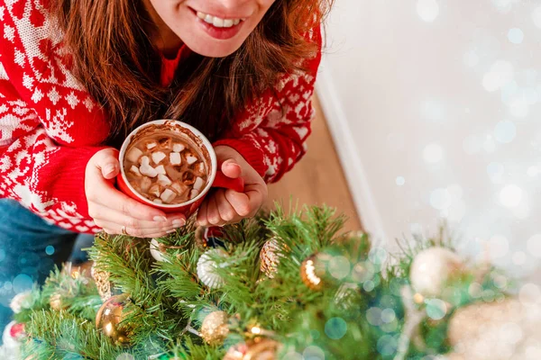 Kırmızı Kazaklı Genç Bir Kadın Noel Ağacının Yanında Marşmelovlu Kakao — Stok fotoğraf