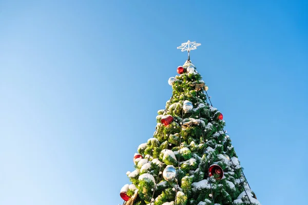 Mavi Bir Arka Planda Karla Kaplanmış Süslü Noel Ağacı — Stok fotoğraf