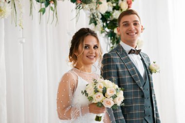 Tarz sahibi mutlu yeni evliler, zarif ve memnun bir gelin. Yeni evliler toplanıyor.