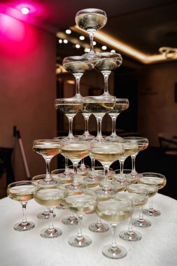 Pyramid of champagne glasses. Luxurious life.