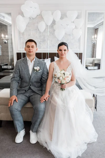 Wedding Couple Holding Hands Sitting Bed Looking Seriously Camera — Foto de Stock