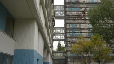 Yüksek bir konut binasında alışılmadık balkonlar, aşağıdan manzara. Binanın garip geometrisi. Doli kamera görüntüsü