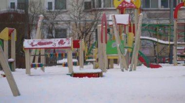 Terk edilmiş çocuklar için oyun parkı kar yağışı sonrası karla kaplı.