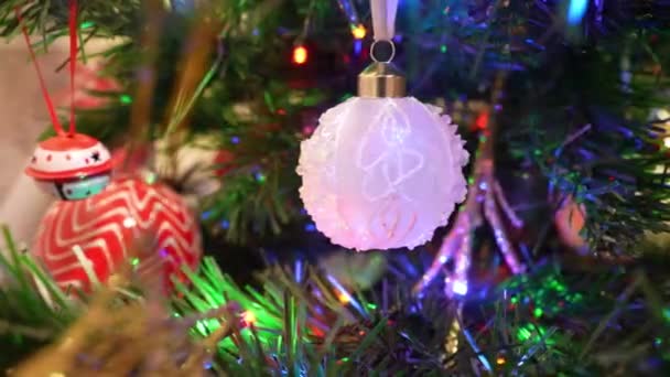 Christmas tree toys on an artificial Christmas tree close-up. Dolly camera shot — Vídeo de Stock