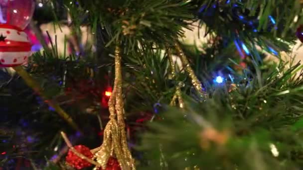 Christmas tree toys on an artificial Christmas tree close-up. Dolly camera shot — 图库视频影像
