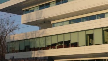 The facade and windows of the modern futuristic building are close-ups of winter. Modern office building. Beautiful business center