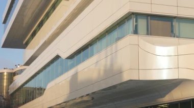 The facade and windows of the modern futuristic building are close-ups of winter. Modern office building. Beautiful business center