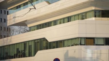 The facade and windows of the modern futuristic building are close-ups of winter. Modern office building. Beautiful business center