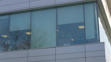 The facade and windows of the modern futuristic building are close-ups of winter. Modern office building. Beautiful business center