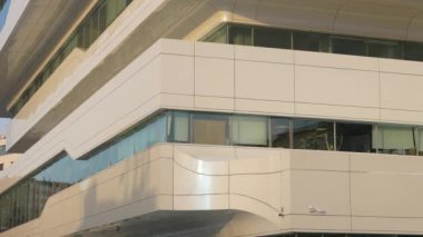 The facade and windows of the modern futuristic building are close-ups of winter. Modern office building. Beautiful business center