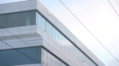 The facade and windows of the modern futuristic building are close-ups of winter. Modern office building. Beautiful business center