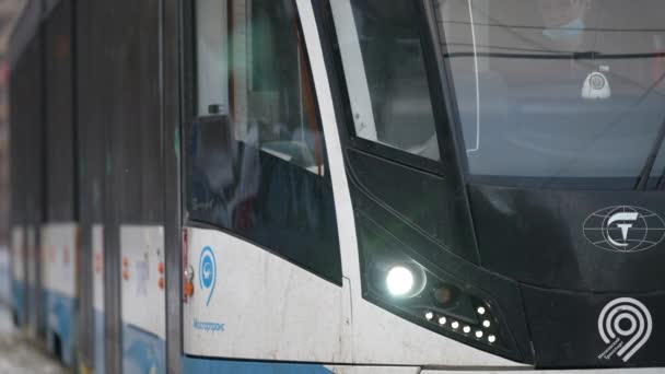 Moscow, Russia - January 2022: A male passenger enters a modern tram in winter. Tram doors are closed — 图库视频影像