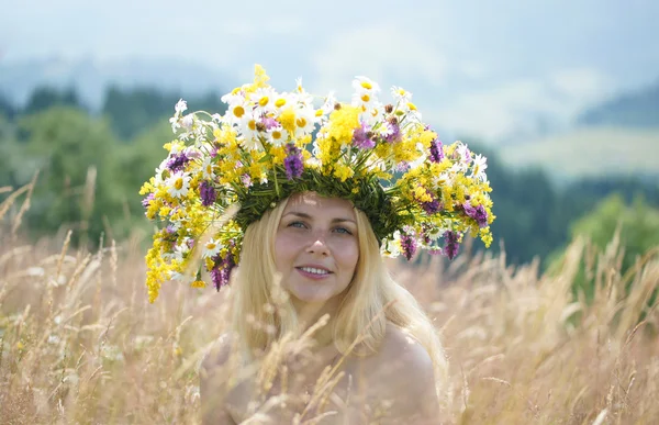 Girl in big wreath on a meadow — Stock Photo, Image