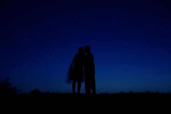 Night sky with the silhouette figures — Stock Photo, Image