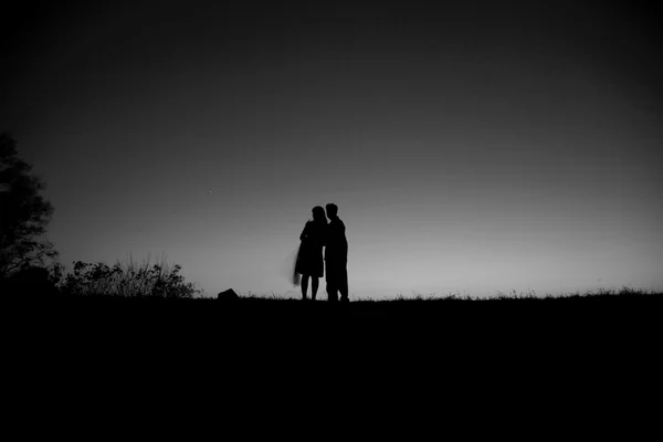 Night sky with the silhouette figures — Stock Photo, Image