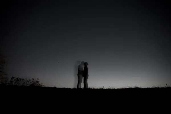 Night sky with the silhouette figures — Stock Photo, Image