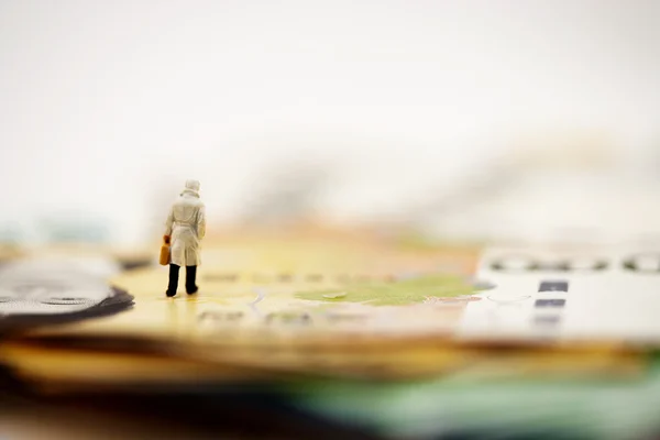 Tiny figure on the money — Stock Photo, Image