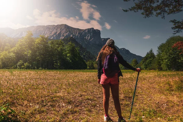 young woman walking in the French alps admiring the view , adventure holidays .