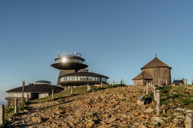 Old wooden church on the top of Snezka,the highest mountain of Czech Republic,Krkonose Mountains.Chapel of Saint Lawrence and Polish chalet.Hiking to the summit.Sunny day in Czech countryside