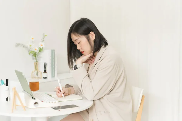 asian business and writer woman writing new her idea on book