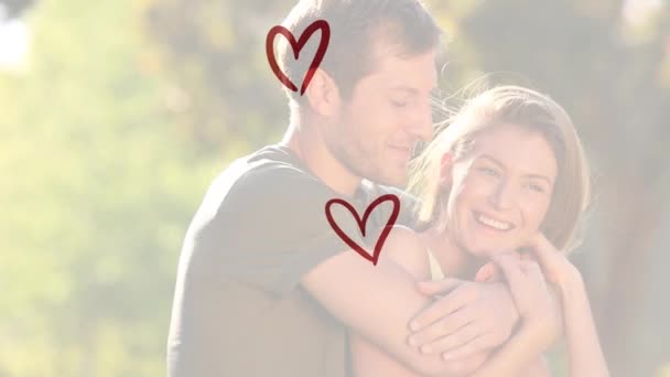 白人夫婦の笑顔と抱擁上の赤い心のアニメーション 婚約恋愛愛の概念をデジタルで生成したビデオ — ストック動画