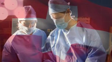 Ameliyathanede cerrahların üzerinde bayrak sallama animasyonu. küresel tıp, covid 19 pandemik konsept sırasında sağlık hizmetleri dijital olarak üretilen video.