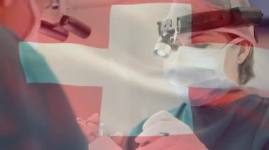 Ameliyathanede cerrahların üzerinde bayrak sallama animasyonu. küresel tıp, covid 19 pandemik konsept sırasında sağlık hizmetleri dijital olarak üretilen video.