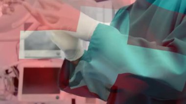 Ameliyathanede cerrahın üzerinde bayrak sallama animasyonu. küresel tıp, covid 19 pandemik konsept sırasında sağlık hizmetleri dijital olarak üretilen video.