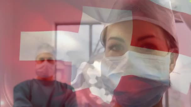Animación Bandera Suiza Ondeando Sobre Cirujanos Quirófano Medicina Global Servicios — Vídeo de stock