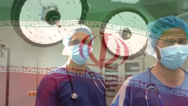 Animação Bandeira Iran Acenando Sobre Cirurgiões Sala Operações Medicina Global — Vídeo de Stock