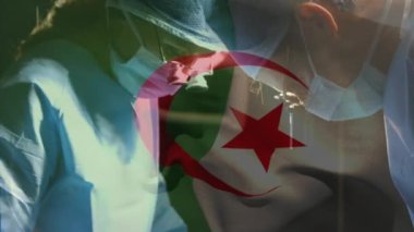 Ameliyathanede cerrahların üzerinde sallanan Cezayir bayrağının animasyonu. küresel tıp, covid 19 pandemik konsept sırasında sağlık hizmetleri dijital olarak üretilen video.