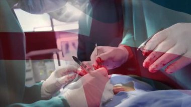 Ameliyathanede cerrahların üzerinde sallanan İngiltere bayrağının animasyonu. küresel tıp, covid 19 pandemik konsept sırasında sağlık hizmetleri dijital olarak üretilen video.