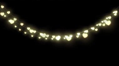 Siyah arka planda asılı dekoratif kalp şeklindeki peri ışıklarının dijital animasyonu. Noel kutlaması geleneği