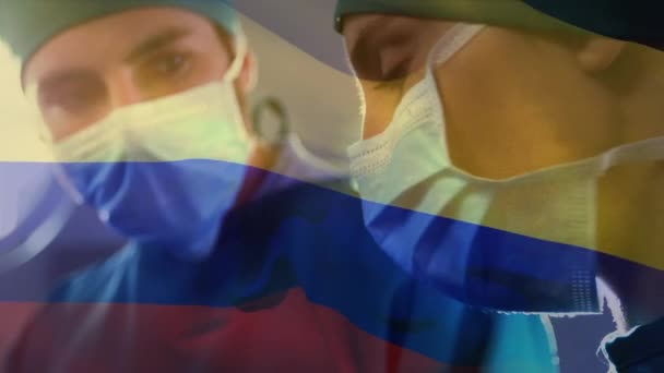 手術室で外科医に手を振ってコロンビアの旗のアニメーション 世界中の医療や医療サービスをデジタル化し — ストック動画