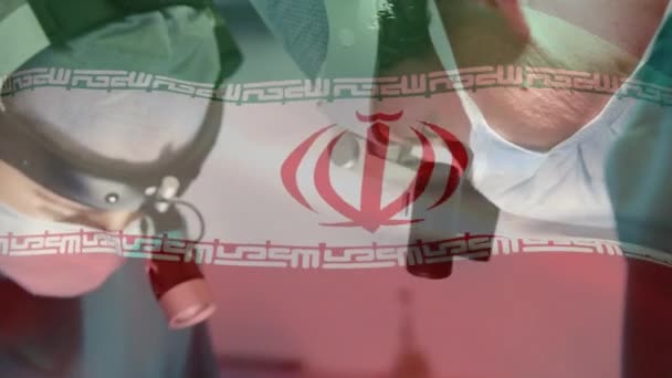 Animación Bandera Irán Ondeando Sobre Cirujanos Quirófano Medicina Global Servicios — Vídeo de stock
