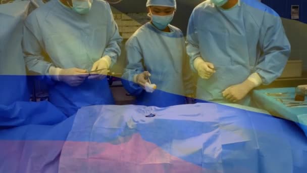Κινούμενη Σημαία Της Κολομβίας Κυματίζει Πάνω Χειρουργούς Στο Χειρουργείο Παγκόσμια — Αρχείο Βίντεο