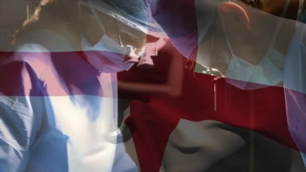 Animación Bandera Inglaterra Ondeando Sobre Cirujanos Quirófano Medicina Global Servicios — Vídeos de Stock
