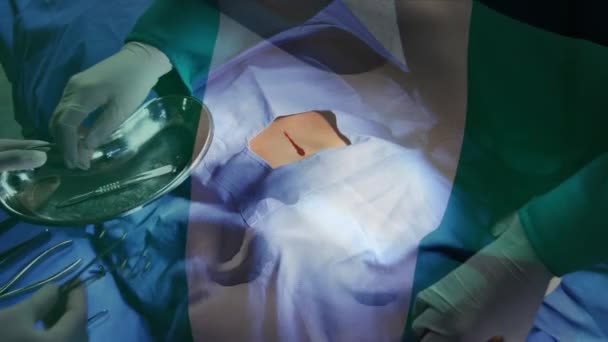 Animación Bandera Nigeria Ondeando Sobre Cirujanos Quirófano Medicina Global Servicios — Vídeo de stock