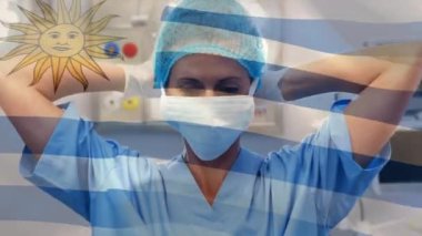 Ameliyathanede kadın cerrahın üzerinde sallanan Uruguay bayrağının animasyonu. küresel tıp, covid 19 pandemik konsept sırasında sağlık hizmetleri dijital olarak üretilen video.