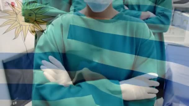 Animación Bandera Uruguay Ondeando Sobre Cirujanos Quirófano Medicina Global Servicios — Vídeo de stock