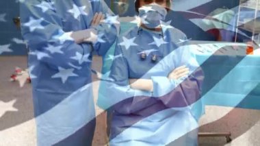 Ameliyathanede cerrahların üzerinde sallanan ABD bayrağının animasyonu. küresel tıp, covid 19 pandemik konsept sırasında sağlık hizmetleri dijital olarak üretilen video.