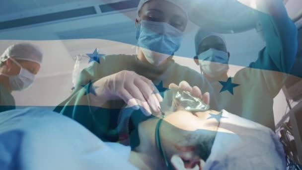 手术室里 在外科医生面前挥动着荣誉旗的动画 全球医学 围产期保健服务 数码制作的19种流行病概念视频 — 图库视频影像