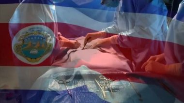 Kosta Rika bayrağının ameliyathanede cerrahların üzerinde dalgalanması. küresel tıp, covid 19 pandemik konsept sırasında sağlık hizmetleri dijital olarak üretilen video.