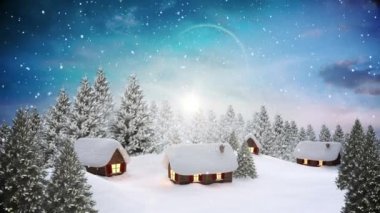 Kış manzarasında birçok ağaç ve evin üzerine düşen karla süslenmiş Noel çelengi. Noel şenliği ve kutlama konsepti