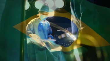 Ameliyathanede cerrahların üzerinde sallanan Brezilya bayrağının animasyonu. küresel tıp, covid 19 pandemik konsept sırasında sağlık hizmetleri dijital olarak üretilen video.