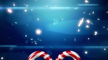 Mavi arka planda şeker kamışı üzerinde kayan yıldızların animasyonu. Noel, gelenek ve kutlama konsepti dijital olarak oluşturuldu.