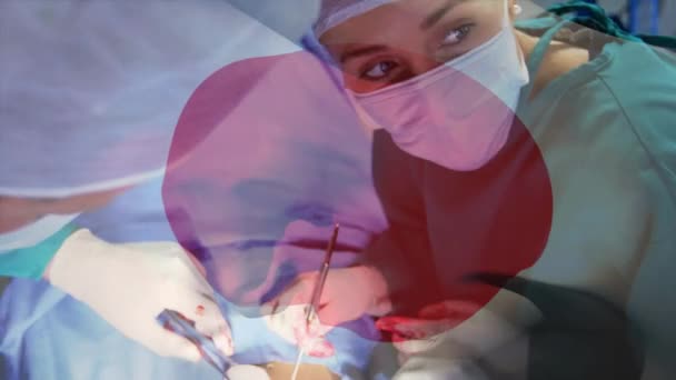 Animación Bandera Japón Ondeando Sobre Cirujanos Quirófano Medicina Global Servicios — Vídeo de stock